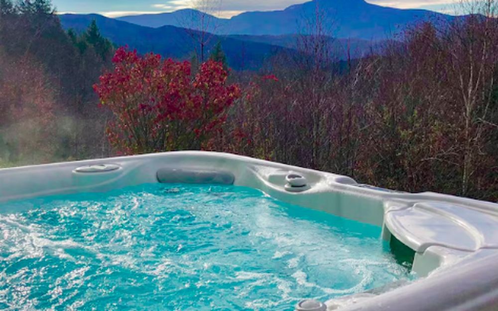 Hot tub overlooking a mountain view at a vacation rental
